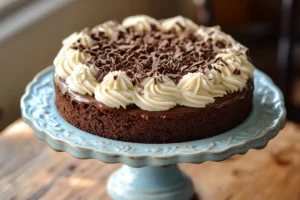 Frosted German chocolate cake slice on a plate with coconut-pecan frosting