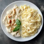 Plate of creamy Chicken Alfredo pasta with fettuccine and grilled chicken