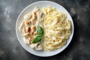 Plate of creamy Chicken Alfredo pasta with fettuccine and grilled chicken