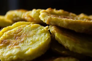 Golden fried green tomatoes in a cast-iron skillet